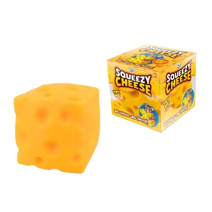A yellow-orange squeaky cheese toy shaped like a Swiss cheese cube next to its yellow retail box labeled 'Squeezy Cheese' on a plain white background.