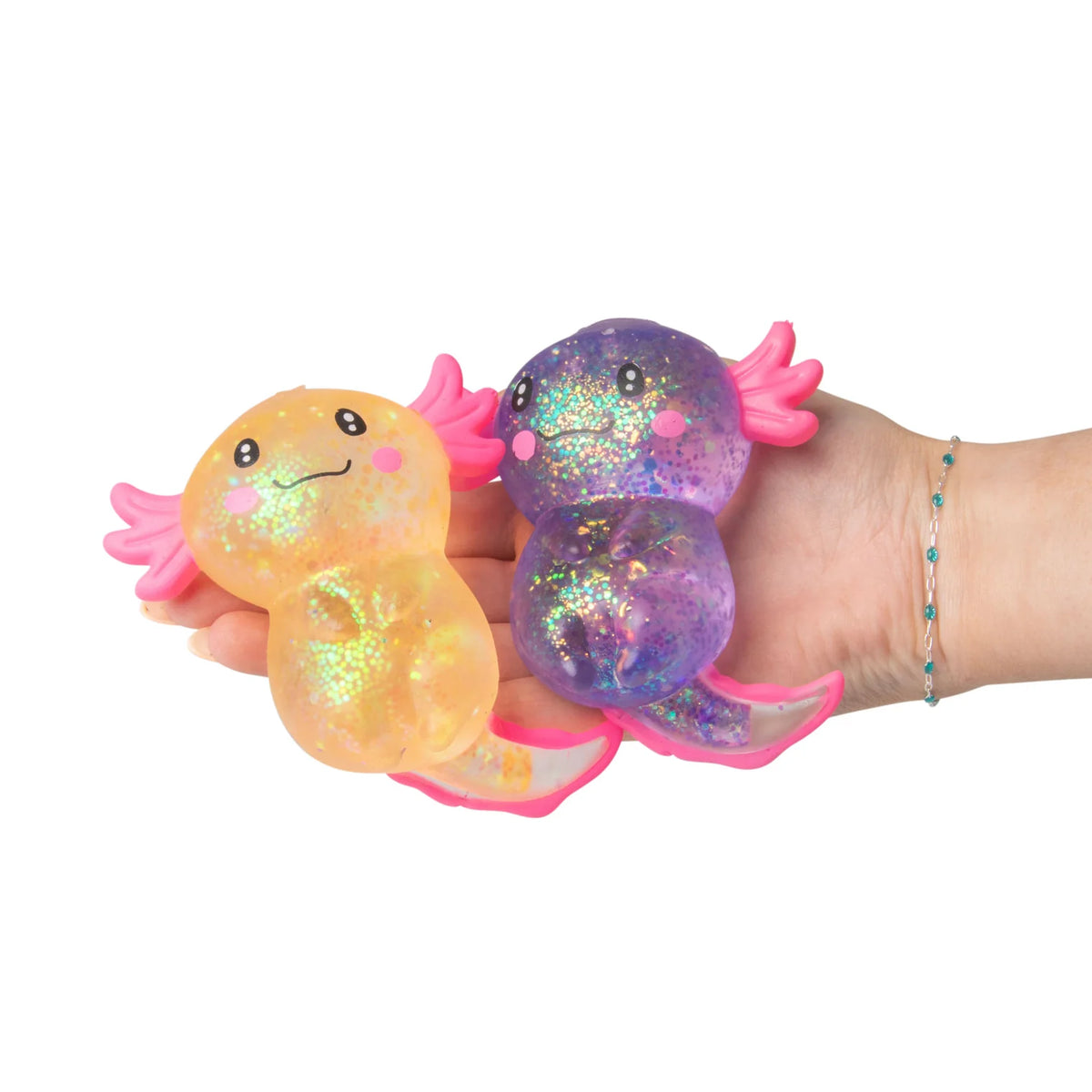 Two colorful squishy toys held in a hand against a white background