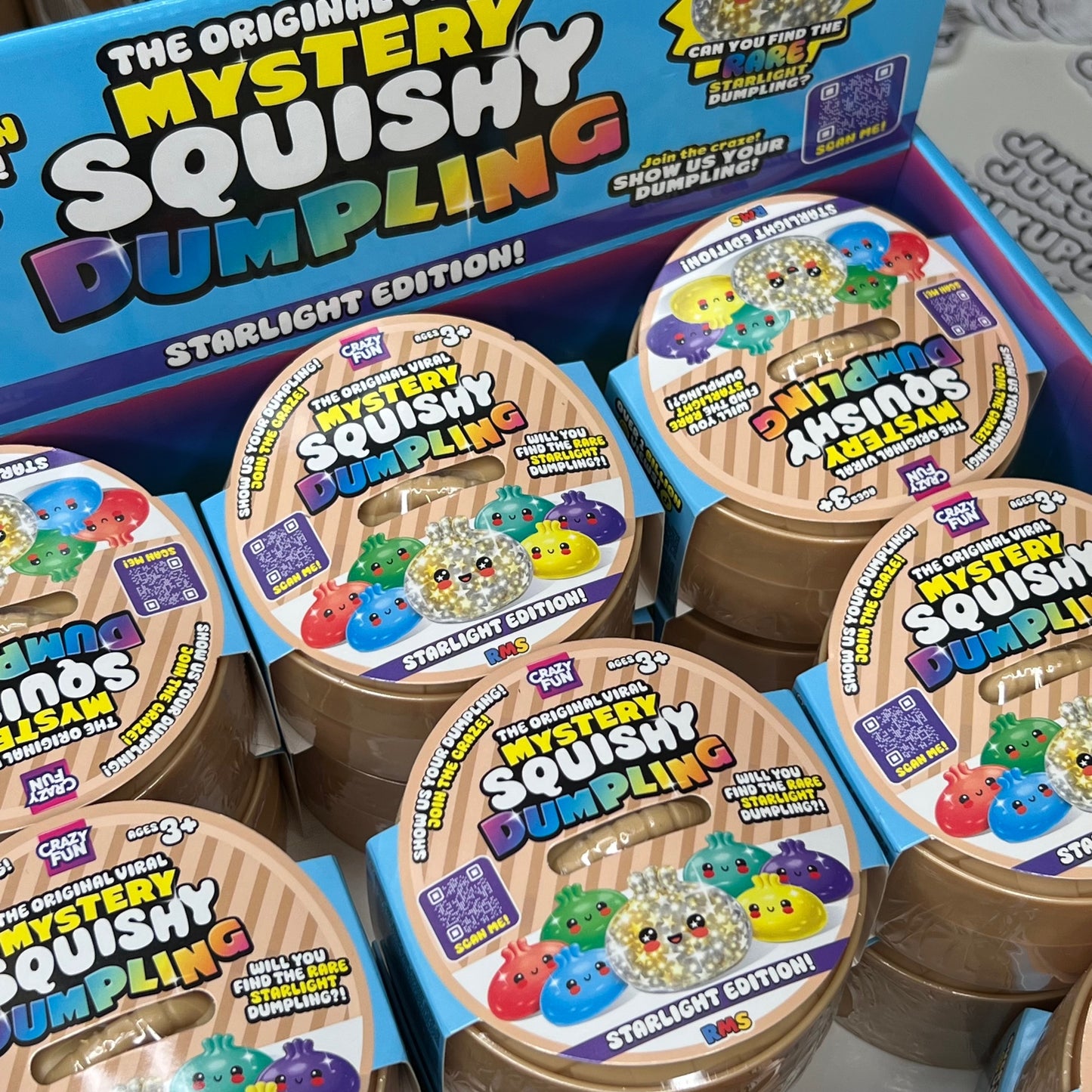 Box of Mystery Squishy Dumpling toys with colorful labels