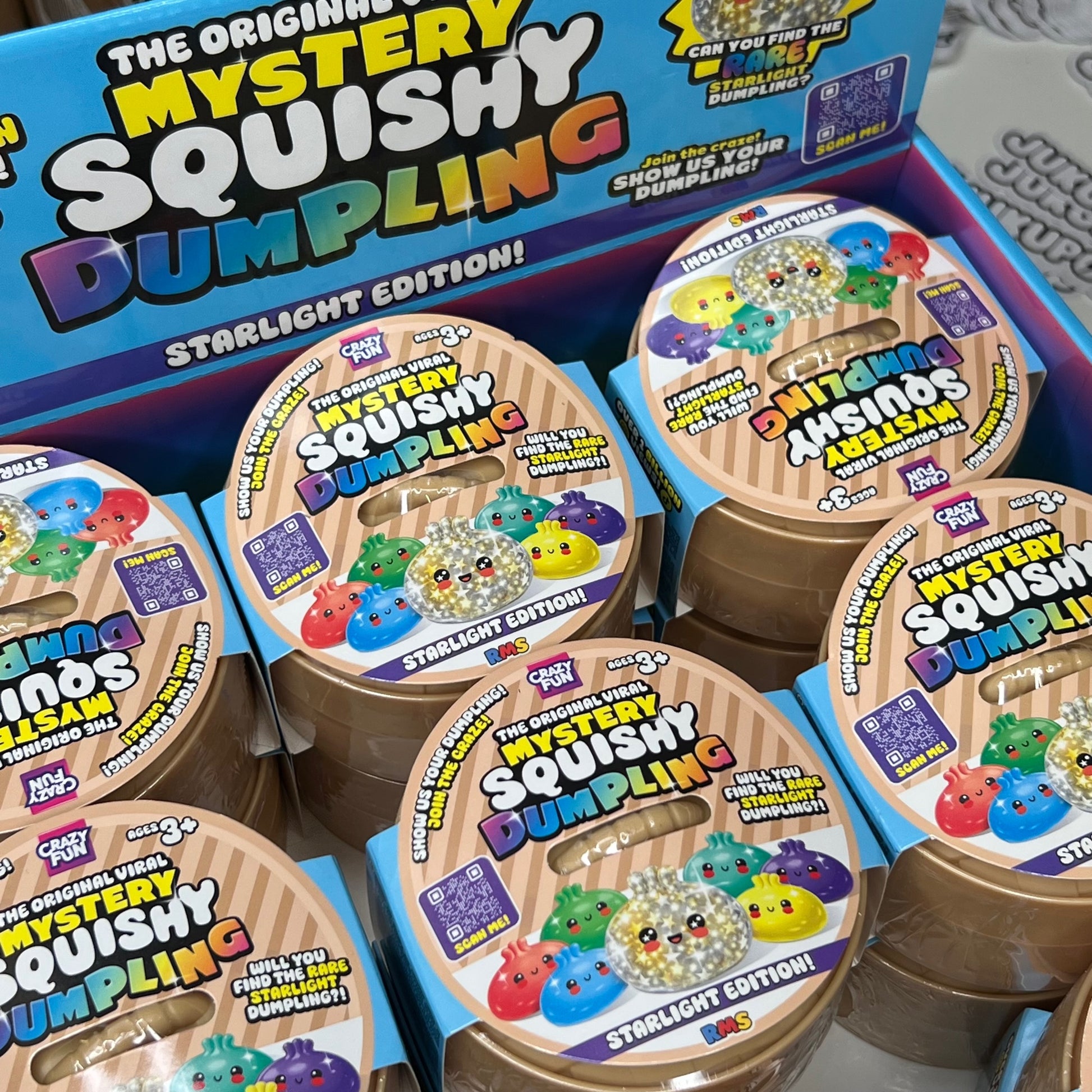 Box of Mystery Squishy Dumpling toys with colorful labels