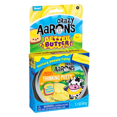 Crazy Aaron's Better Butter Thinking Putty in a round tin with its retail cardboard packaging, featuring yellow, blue, and green colors with a cow illustration.